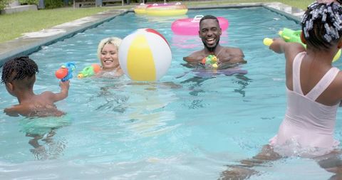 Happy Family Bonding in Pool On Sunny Day With Splashing Fun