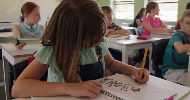 Elementary Student Drawing in Notebook During Class - Download Free Stock Images Pikwizard.com