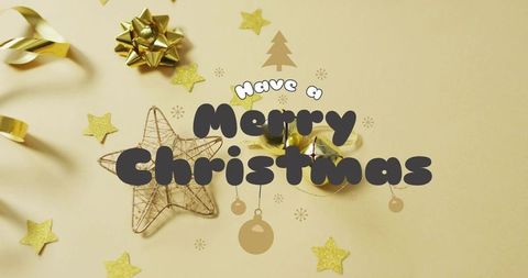 Merry christmas greeting featuring gold wire star, ribbon bow and bells flatlay