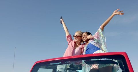 Joyful Friends Enjoying Sunny Road Trip in Convertible