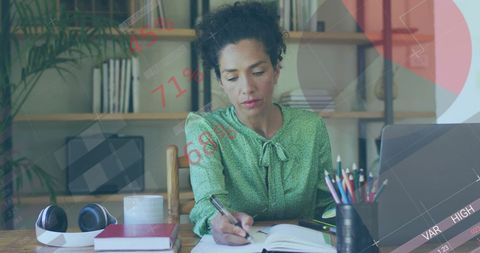Woman Analyzing Financial Data on Laptop in Modern Office