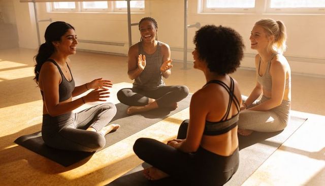 Group Yoga Circle Practicing Mindful Stretching and Laughter in Sunlit Fitness Studio