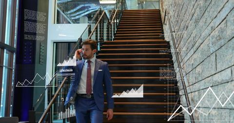 Businessman walking down staircase speaking on phone with financial analytics overlay