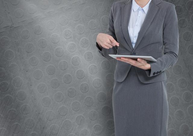 Confident Businesswoman Using Tablet with Grey Textured Background - Download Free Stock Photos Pikwizard.com