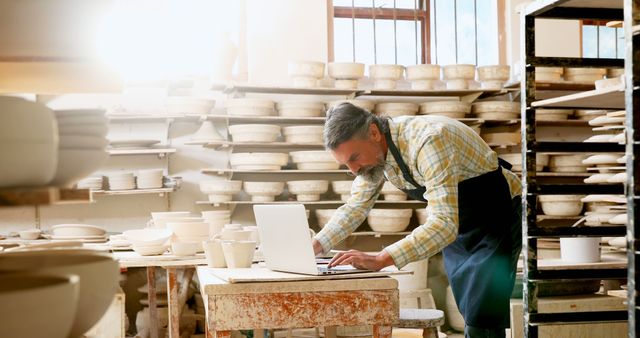 A potter merges tradition with technology in his ceramic-filled workshop. - Download Free Stock Photos Pikwizard.com