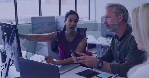 Diverse Team Collaborating With Technology in Modern Office Environment