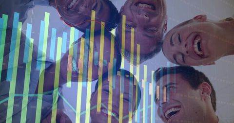 Smiling team leaning inward, collaborating around table with translucent data overlay