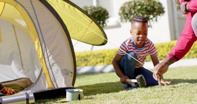 Father and Son Setting Up Tent at Campsite Together - Download Free Stock Images Pikwizard.com