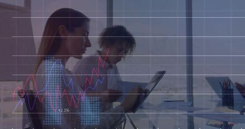 Female Colleagues Analyzing Digital Financial Charts on Tablet in Modern Office with City View