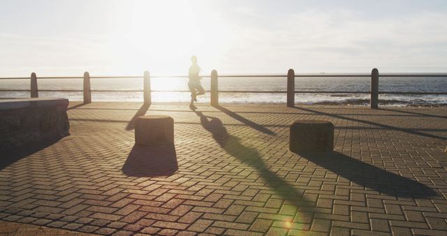 Man Jogging Along Seaside Promenade at Sunset - Download Free Stock Images Pikwizard.com