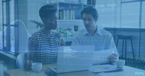 Collaborating on financial data analytics with laptop and digital charts overlay