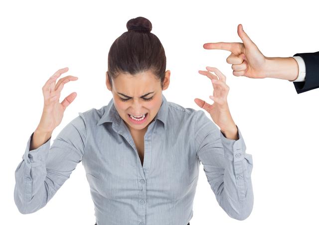 Businesswoman experiencing stress while being blamed by a colleague. Can be used in articles or presentations about workplace stress, corporate conflict, mental health, and office environments.
