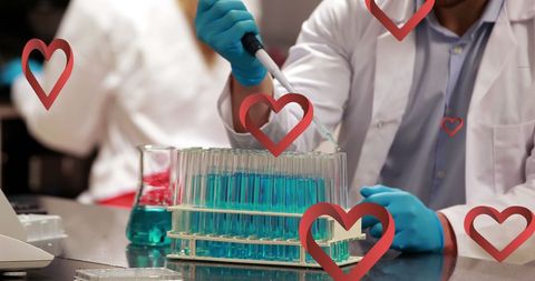 Scientist conducting experiment with test tubes and heart icons