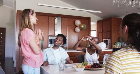 Friends Enjoying Party at Home with Food and Drinks