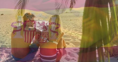 Couple watching sunset through spanish flag overlay on tropical beach, romantic travel
