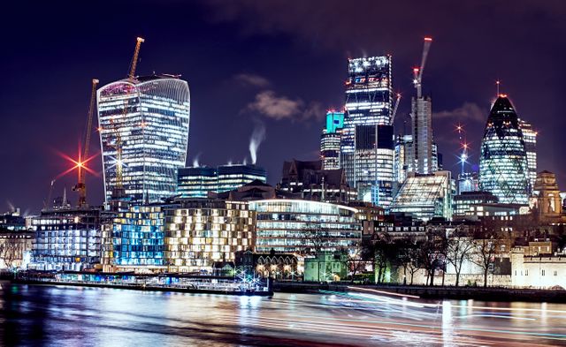 Vibrant London night skyline showcasing illuminated buildings and busy city life. Ideal for use in travel brochures, websites promoting London, business presentations, technology blogs, and urban lifestyle magazines.