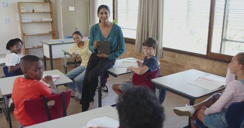 Diverse Classroom with Enthusiastic Teacher Using Tablet Technology