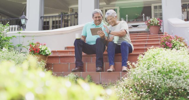 Image of happy biracial senior couple using tablet in garden - Download Free Stock Photos Pikwizard.com