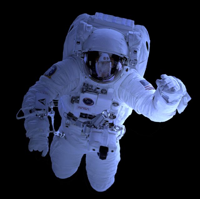 Astronaut in space suit floating in the dark void of space with visible reflections on helmet. Perfect for illustrating themes around space exploration, astronautics, scientific research, space travel, and NASA missions. Can be used in educational material, science blogs, sci-fi projects, or articles about human space exploration.
