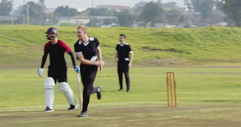 Cricketers in Action on Field During Match Competition Game
