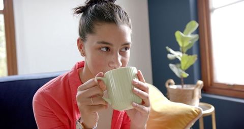 Teen Girl Enjoying Relaxing Moment with Hot Beverage at Home