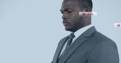 Businessman in Dark Suit with Digital Heart Notifications