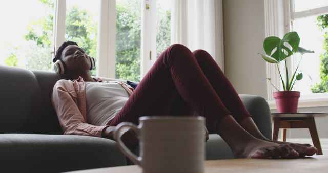 Relaxed Person Listening to Music on Sofa with Headphones - Download Free Stock Images Pikwizard.com