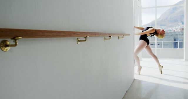 Ballet Dancer Stretching by Window in Studio - Download Free Stock Images Pikwizard.com