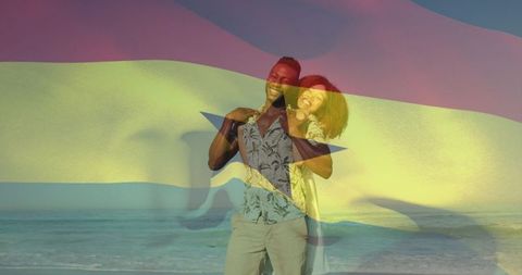 Couple embracing on beach at sunset with ghana flag overlay double exposure lifestyle