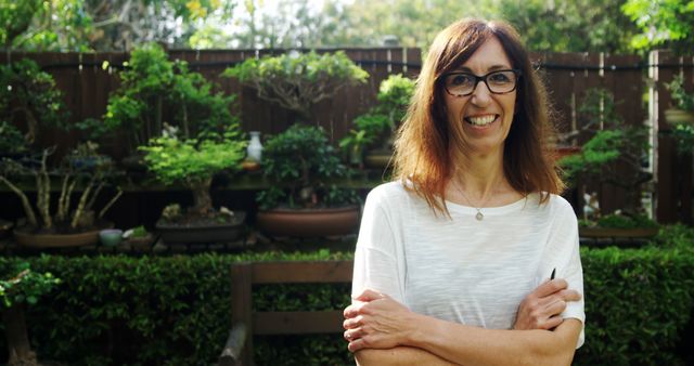 Smiling Woman in Garden with Sunglasses Relaxing Outdoors - Download Free Stock Images Pikwizard.com