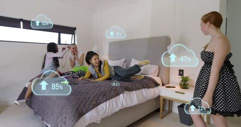 Young women laughing on bed with augmented reality cloud upload graphics for social sharing