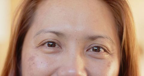Close-Up Portrait of Mature Asian Woman with Natural Expression