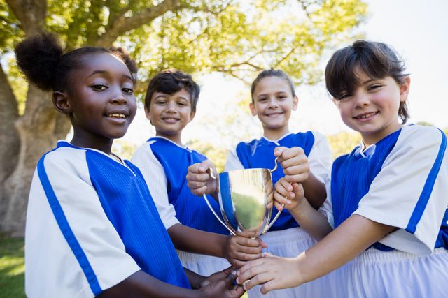 Happy children soccer team holding cup  - Download Free Stock Photos Pikwizard.com