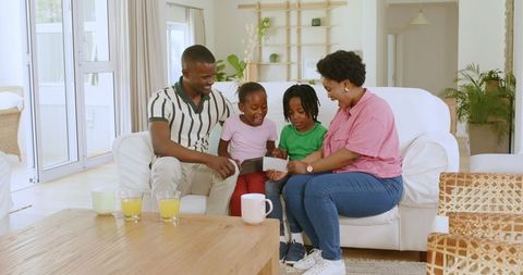 Happy African American Family Celebrating in Living Room