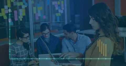 Team Collaborating in Modern Office with Laptops and Sticky Notes