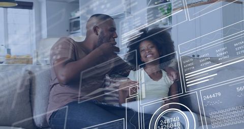 Father and Daughter Enjoying TV with Digital Data Interface
