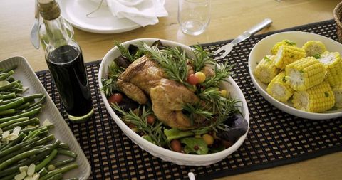 Herb-Roasted Whole Chicken on Mixed Greens with Corn and Green Beans for Family Dinner