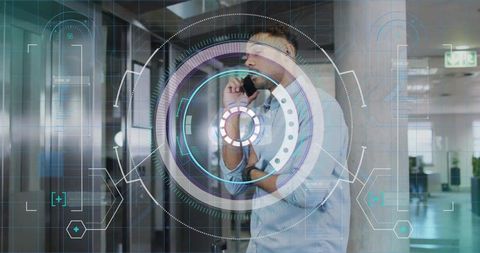 Businessman talking on smartphone with futuristic hud interface in modern office lobby