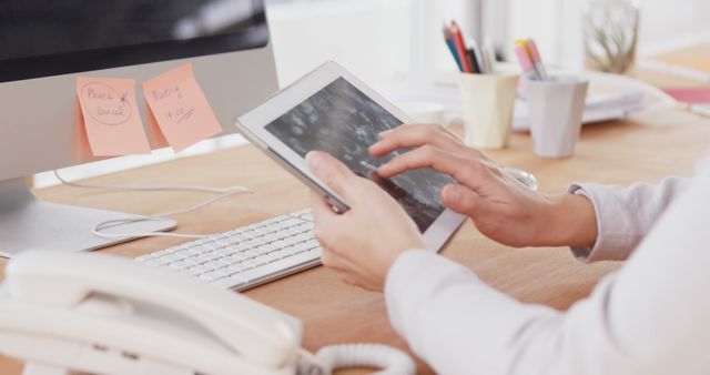 Businessperson using tablet at modern office desk - Download Free Stock Images Pikwizard.com