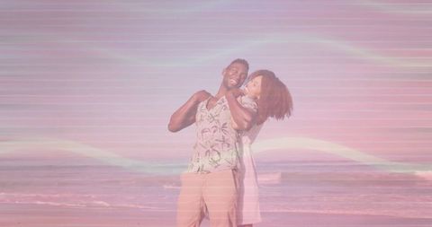 Couple Embracing at Sunset Beach with Pastel Vibes
