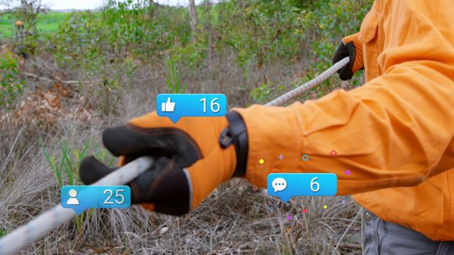 Worker with vibrant orange jacket holding rope in a forest setting, overlaid with social media interaction icons such as likes, messages, and follower counts. This striking combination of natural environment and modern digital concept illustrates the convergence of traditional work with new-age communication technologies. Perfect for use in articles and presentations about digital transformation, the intersection of technology and manual labor, and technology's reach in everyday activities.