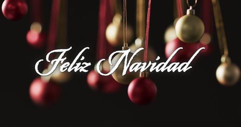 Feliz Navidad Greeting with Christmas Baubles on Dark Background