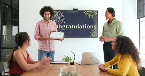 Colleagues Celebrating Achievement at Office Meeting