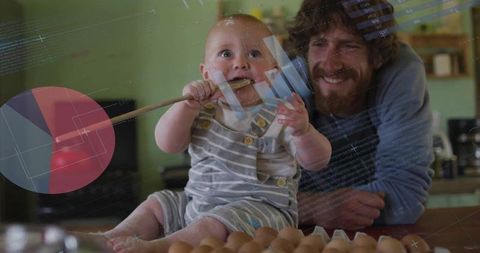 Father and infant son in kitchen with coding overlay