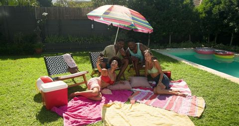Diverse Friends Enjoying Summer Day by Pool with Selfie