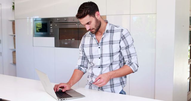 Man Working on Laptop in Modern Kitchen - Download Free Stock Images Pikwizard.com