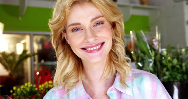 Smiling Blonde Woman in Flower Shop with Checkered Shirt - Download Free Stock Images Pikwizard.com