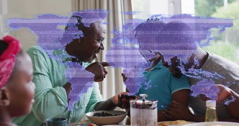 Senior Man Pointing and Smiling with Child at Morning Breakfast Table with French Press