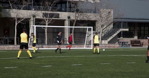 Soccer Players Strategizing During Intense Match
