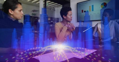 Executives discussing holographic city model in futuristic office
